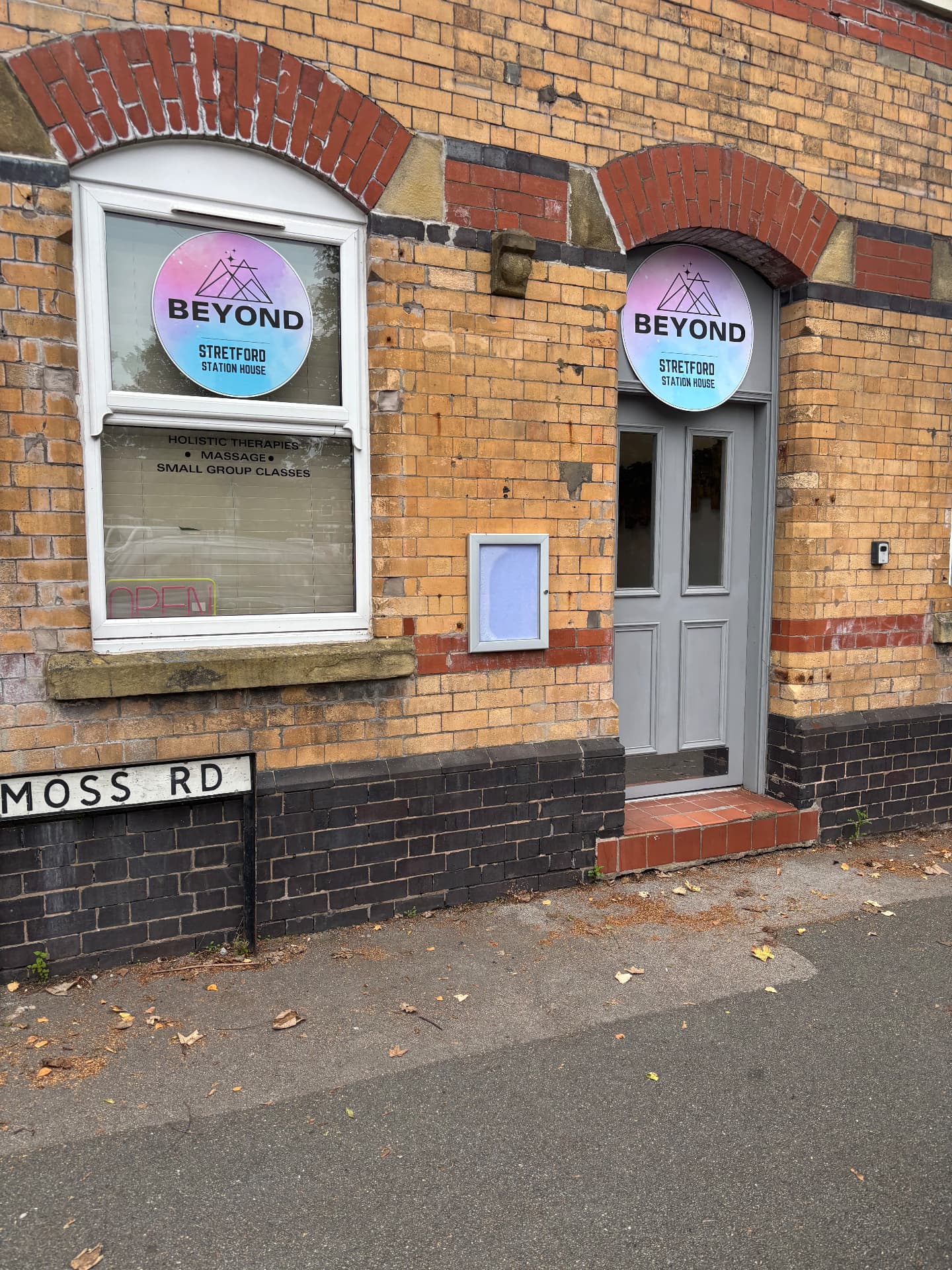 The Beyond entrance and shopfront at Stretford Station House on Moss Road